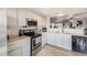 Bright, airy kitchen with stainless steel appliances, light gray cabinets, and natural light at 11009 Gaylord St, Northglenn, CO 80233