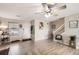 Bright living room with modern wood floors, neutral tones, ceiling fan, and stairs at 11009 Gaylord St, Northglenn, CO 80233