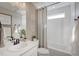Cozy bathroom features a shower-tub combo, white vanity, and decorative elements for added charm at 1218 Sugarloaf Ln, Erie, CO 80516