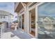 Outdoor patio view showcasing sliding glass doors to the interior, with a cozy chair set at 1218 Sugarloaf Ln, Erie, CO 80516