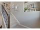 Bright staircase with carpeted steps, black metal railing, and artful decor at 1218 Sugarloaf Ln, Erie, CO 80516