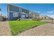 Beautiful backyard with a lush lawn, fenced perimeter, and gravel path at 2417 Mountain Sky Dr, Fort Lupton, CO 80621