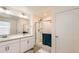 Bright bathroom showcasing a double sink vanity and a glass-enclosed shower at 2417 Mountain Sky Dr, Fort Lupton, CO 80621