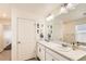 Bathroom featuring a double sink vanity and a separate door to the toilet and shower at 2417 Mountain Sky Dr, Fort Lupton, CO 80621