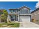 Charming two-story home with a manicured front yard and attached two-car garage at 2417 Mountain Sky Dr, Fort Lupton, CO 80621