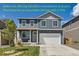 Charming two-story home with a well-maintained lawn and attached two car garage at 2417 Mountain Sky Dr, Fort Lupton, CO 80621