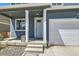 Inviting home exterior with a covered porch and attached garage at 2417 Mountain Sky Dr, Fort Lupton, CO 80621