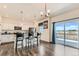 Open kitchen with granite countertops, stainless appliances, bar seating, and sliding doors to the deck at 2417 Mountain Sky Dr, Fort Lupton, CO 80621