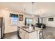 Modern kitchen featuring an island with bar seating, granite countertops, and stainless steel appliances at 2417 Mountain Sky Dr, Fort Lupton, CO 80621