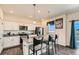 Bright kitchen with granite counters, stainless appliances, and an island with bar seating at 2417 Mountain Sky Dr, Fort Lupton, CO 80621