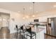 Well-equipped kitchen with stainless steel appliances, granite countertops, and bar stool seating at 2417 Mountain Sky Dr, Fort Lupton, CO 80621
