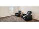 Comfortable sitting room features carpet flooring, reading chairs, and a window at 2417 Mountain Sky Dr, Fort Lupton, CO 80621