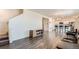 Open-concept living room with modern wood floors flowing into the dining and kitchen areas at 2417 Mountain Sky Dr, Fort Lupton, CO 80621
