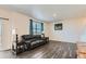Spacious living room with hardwood floors, large windows, and stylish furnishings at 2417 Mountain Sky Dr, Fort Lupton, CO 80621