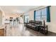 Open-concept living room and kitchen features hardwood floors and lots of natural light at 2417 Mountain Sky Dr, Fort Lupton, CO 80621