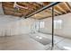 Unfinished basement with concrete floor and exposed beams at 10298 Tall Oaks Cir, Parker, CO 80134