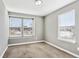 Bright bedroom with neutral walls and carpet, featuring two large windows at 10298 Tall Oaks Cir, Parker, CO 80134