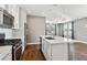 Modern kitchen with white cabinets, island, and gas range at 10298 Tall Oaks Cir, Parker, CO 80134