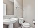 Clean powder room with pedestal sink and toilet at 10298 Tall Oaks Cir, Parker, CO 80134