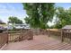 Large wooden deck overlooks private backyard with mature trees at 11823 Steele St, Thornton, CO 80233