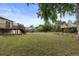 Wide backyard featuring a deck, garden bed, and plenty of open space at 11823 Steele St, Thornton, CO 80233