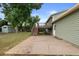 Exterior view of backyard, patio, deck, shed and green siding of home at 11823 Steele St, Thornton, CO 80233