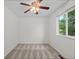 Bright bedroom with a ceiling fan, a window, and neutral carpeting at 11823 Steele St, Thornton, CO 80233