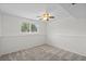 Bedroom with ceiling fan, carpet, and window overlooking backyard at 11823 Steele St, Thornton, CO 80233
