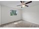Bright bedroom with a ceiling fan, a window, and neutral carpeting at 11823 Steele St, Thornton, CO 80233