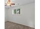 Bright bedroom with a ceiling fan, a window, and neutral carpeting at 11823 Steele St, Thornton, CO 80233