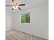 Bright bedroom with a ceiling fan, a window, and neutral carpeting at 11823 Steele St, Thornton, CO 80233