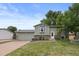 Charming two-story home with landscaped front yard, lush green grass, and attached two-car garage at 11823 Steele St, Thornton, CO 80233