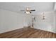 Spacious room featuring wood-look floors, white walls, ceiling fan, and staircase access at 11823 Steele St, Thornton, CO 80233