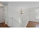 Bright foyer showcasing white banister staircase, chandelier, and wood-look flooring at 11823 Steele St, Thornton, CO 80233