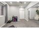 Finished basement area with gray carpet, a window, and storage for weights and exercise equipment at 6777 Larsh Dr, Denver, CO 80221