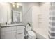 Bathroom features a bathtub, toilet, and updated vanity with granite top at 6777 Larsh Dr, Denver, CO 80221