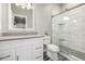 Bathroom featuring tiled floors, a walk-in shower with a glass door, and a modern vanity with a gray countertop at 6777 Larsh Dr, Denver, CO 80221