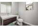 Modern powder room featuring sleek vanity, contemporary fixtures, and a minimalist design at 6777 Larsh Dr, Denver, CO 80221