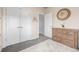 Bedroom featuring neutral paint, carpeted floors, white closet doors, and a dresser with a decorative wreath at 6777 Larsh Dr, Denver, CO 80221