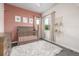 Charming bedroom featuring a crib, soft rug, and natural light, creating a cozy atmosphere at 6777 Larsh Dr, Denver, CO 80221