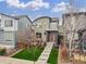 Contemporary two-story home featuring a vibrant red door, landscaped front yard, and inviting curb appeal at 6777 Larsh Dr, Denver, CO 80221