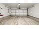 Clean garage with concrete floors, providing a functional space for parking and projects at 6777 Larsh Dr, Denver, CO 80221