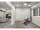 View into a home gym from a recreation space with gray carpeting at 6777 Larsh Dr, Denver, CO 80221