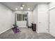 Basement home gym with window, exercise mat, bench, and storage at 6777 Larsh Dr, Denver, CO 80221