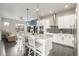 Open concept kitchen with island, stainless steel appliances, and white cabinetry at 6777 Larsh Dr, Denver, CO 80221