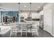 Modern kitchen with white cabinets, stainless steel appliances, and island with seating at 6777 Larsh Dr, Denver, CO 80221