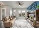 Comfortable living room featuring stylish furnishings, a media center with fireplace, and large window at 6777 Larsh Dr, Denver, CO 80221