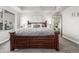 Cozy bedroom featuring a large bed, comfortable bedding, soft lighting, and neutral tones at 6777 Larsh Dr, Denver, CO 80221