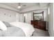 Bright bedroom with a dresser, soft bedding, closet, and a ceiling fan at 6777 Larsh Dr, Denver, CO 80221