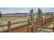 Fenced backyard view with lush field and mountain backdrop at 15226 W 93Rd Ave, Arvada, CO 80007